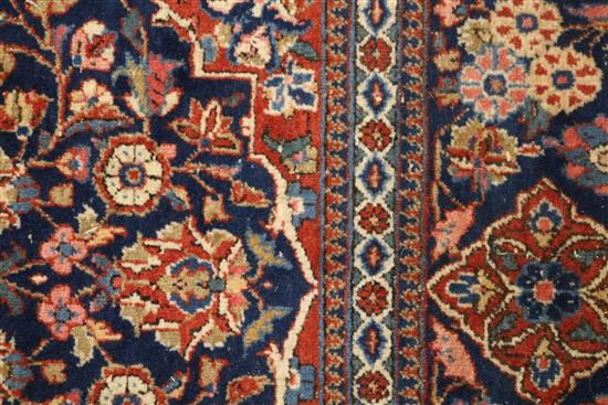 An Isfahan red ground medallion rug 202cm x 133cm